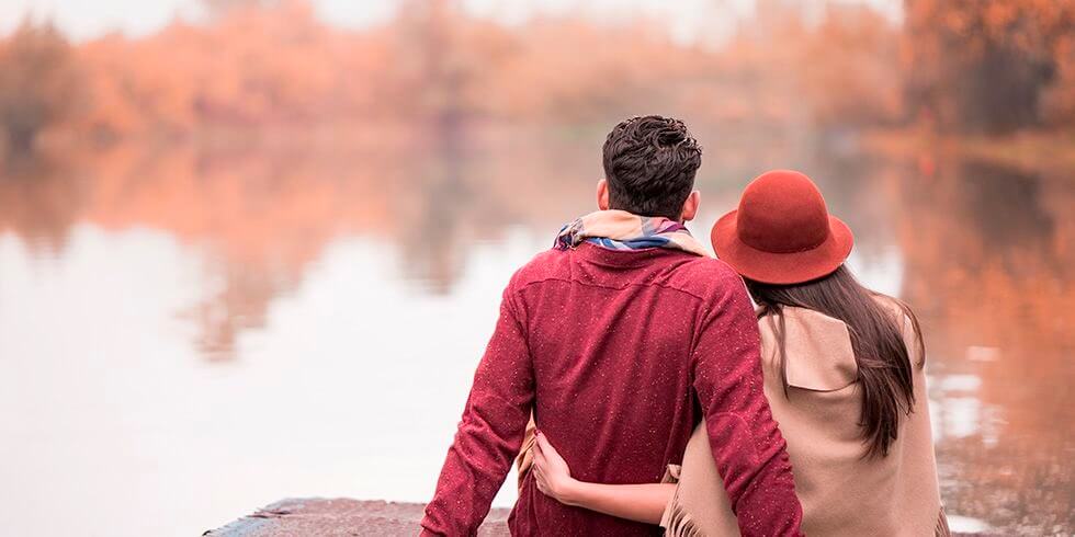 Couple embracing each other over looking a lake