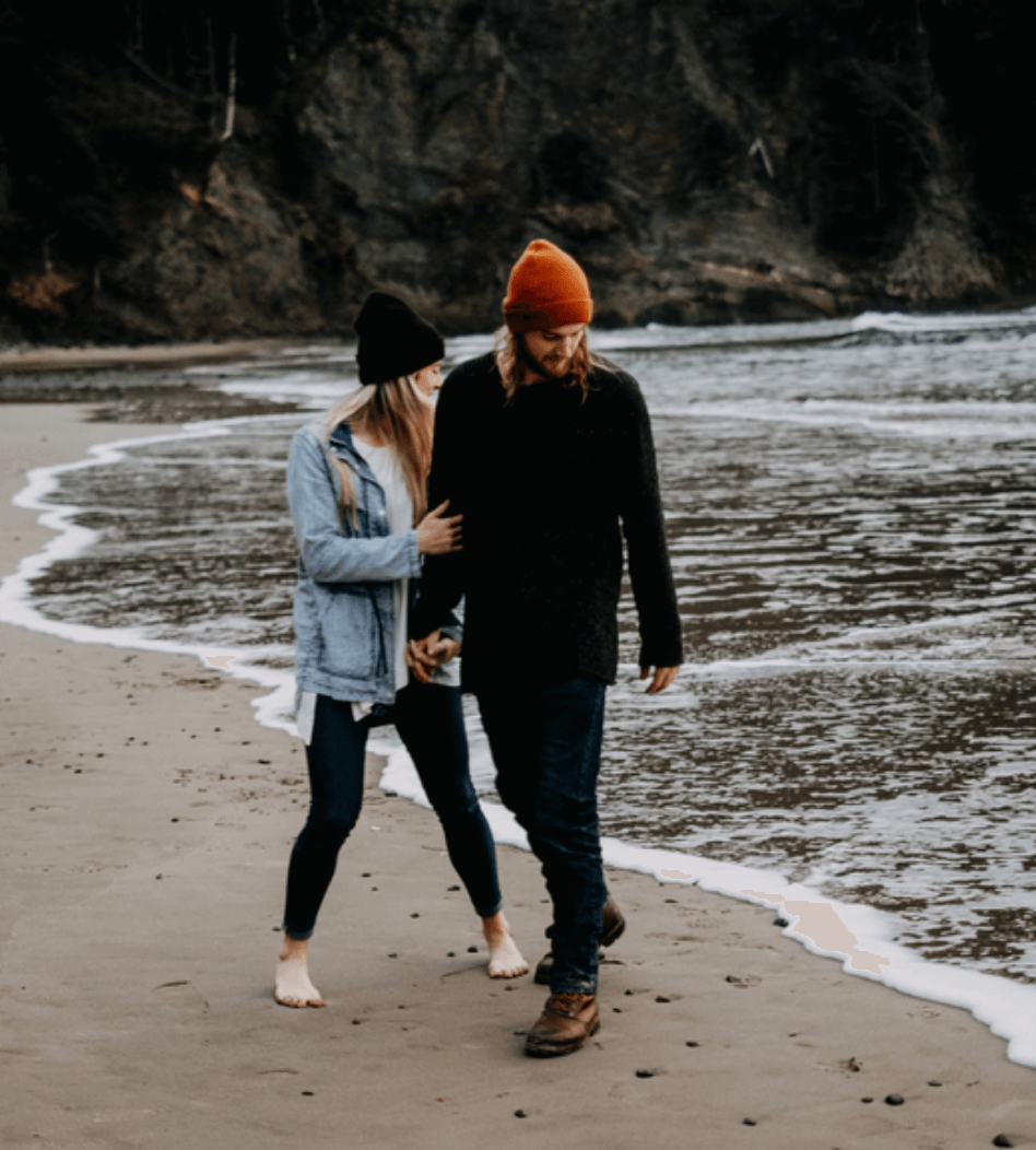 Couple walking on the beach holding hands