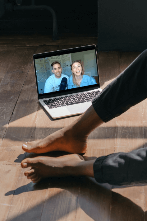 Guy sitting on the floor watching a video on a computer